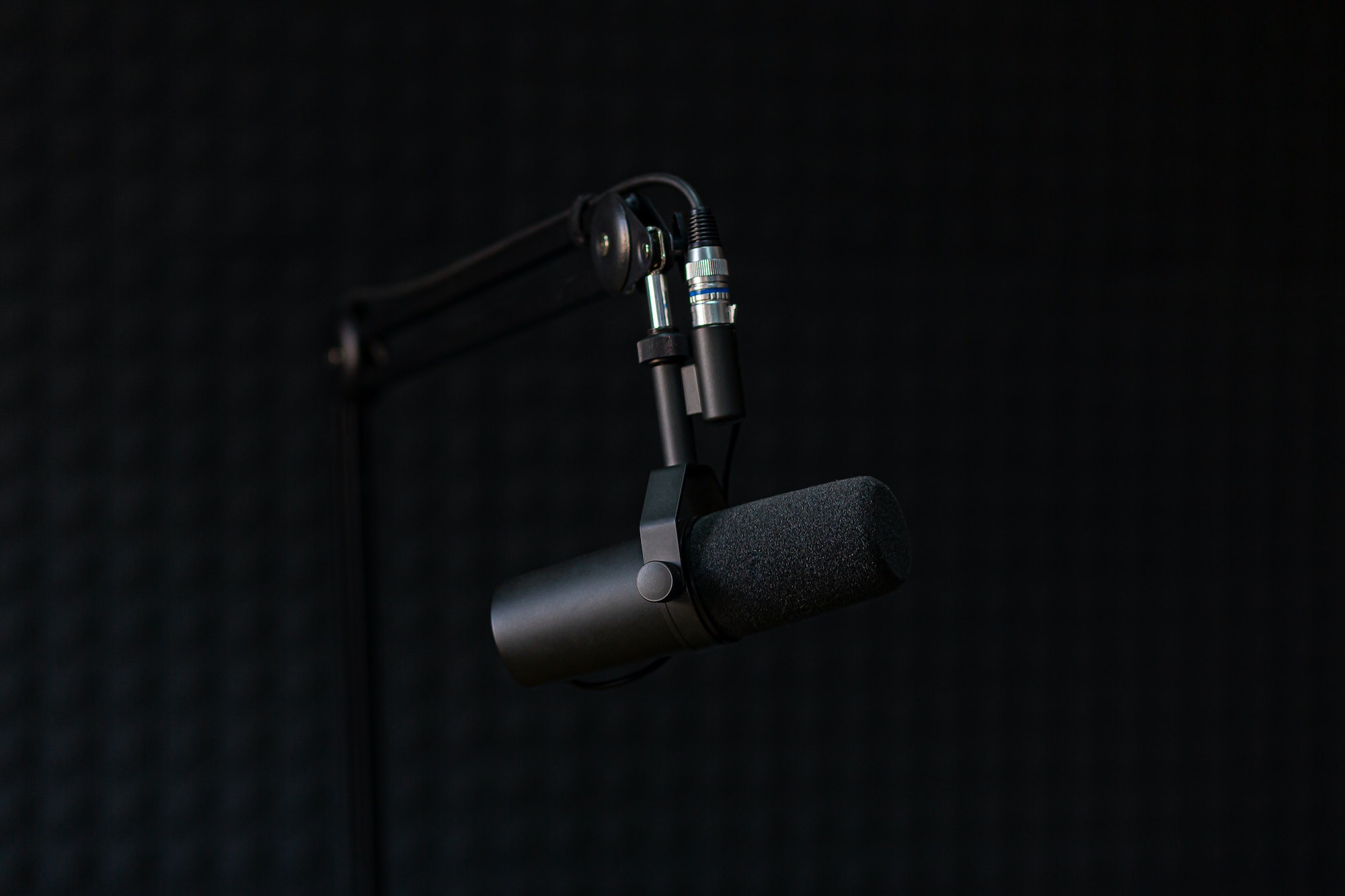 Microphone of recording studio and podcasts, on black background